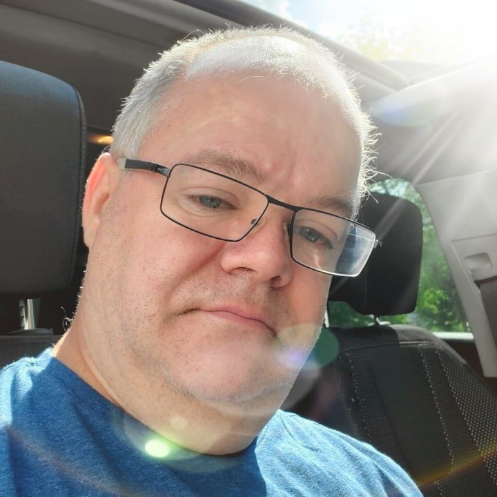 Picture of Lester West on a sunny day in car.